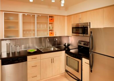 Large kitchen with a refrigerator and stainless steel appliances