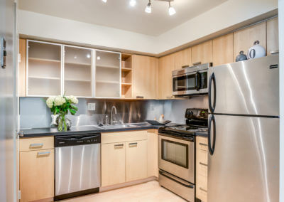 Large kitchen with a refrigerator and stainless steel appliances
